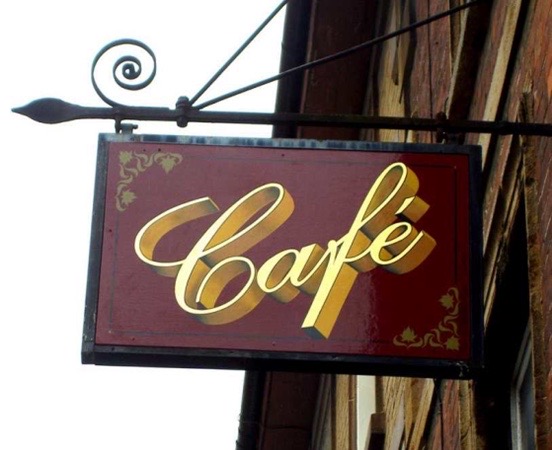 A traditional style hanging sign for a cafe