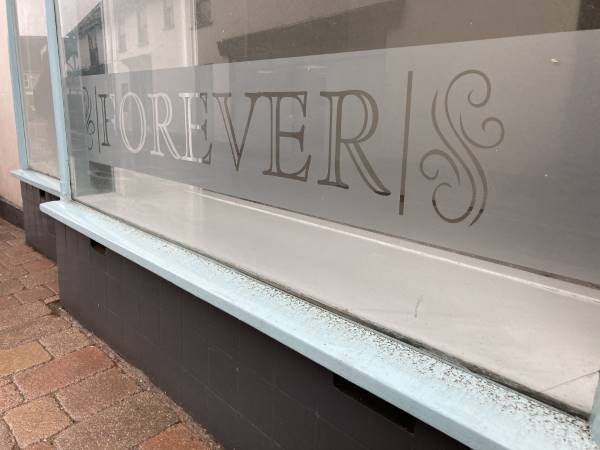 A frosted effect shop window sign