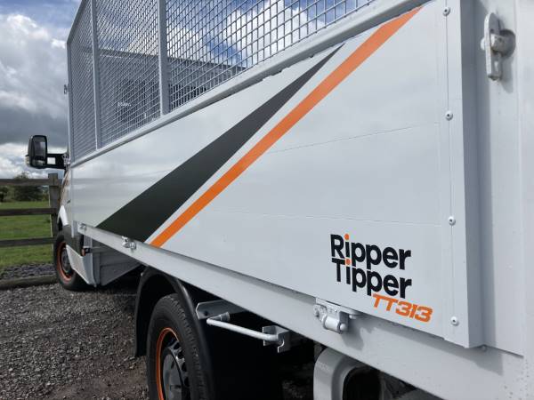 A tipper truck with vinyl graphics